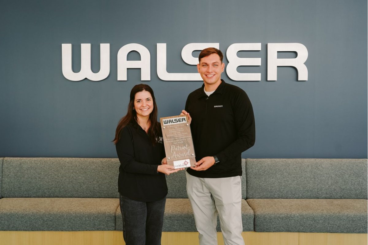 Angela Leathley and Jackson Rusnacko of Walser holding the LockLeed Q2 2026 Patriot Award in front of the Walser sign